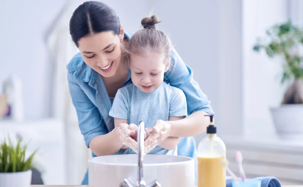 Madre enseñando los hábitos de higiene para niños a su hija
